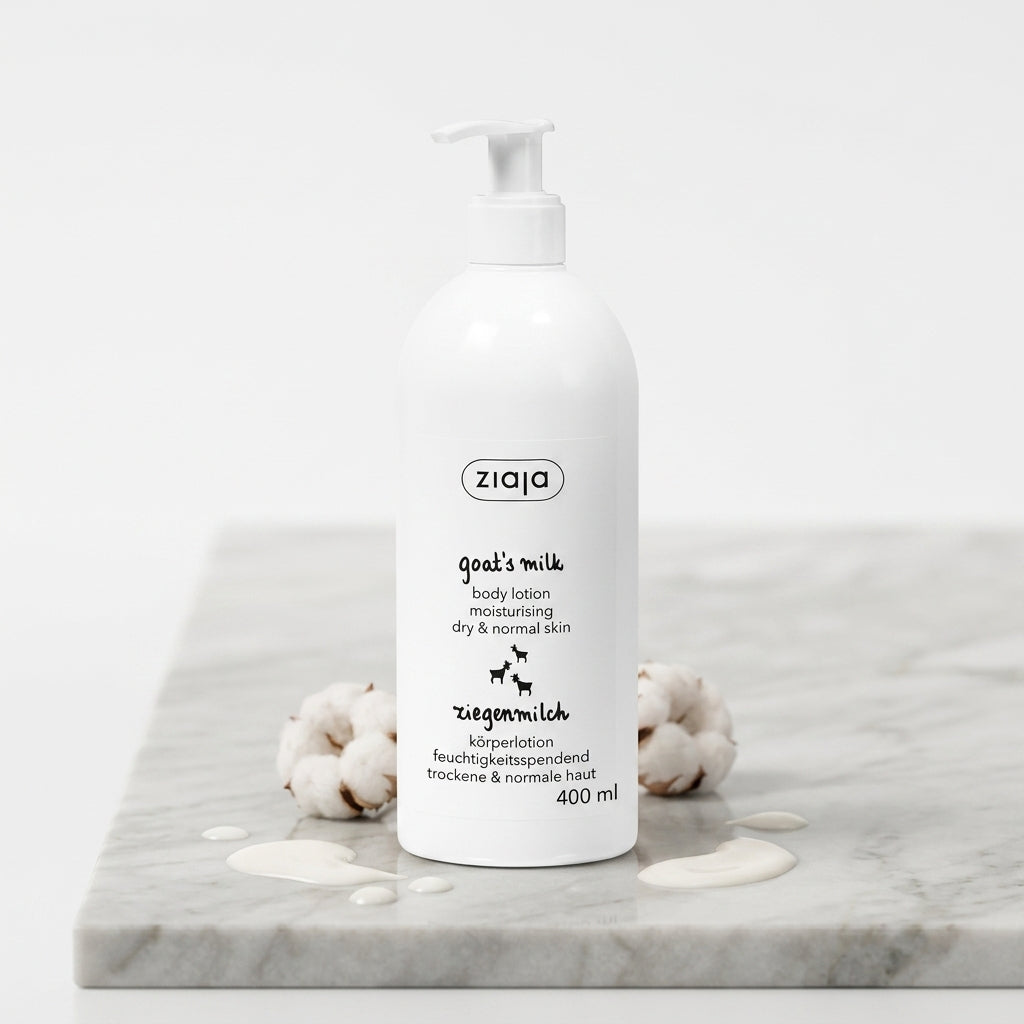 Ziaja Goat Milk Body Lotion 400ml on a premium light marble slab with cotton blossoms